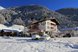 Ein gemütliches Hotel in verschneiter Berglandschaft bietet winterliche Erholung inmitten der Alpen